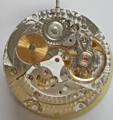 Movement with gear train and balance, only the automatic winding is missing.