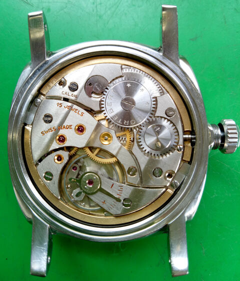 The movement with modified mounting ring in the case.